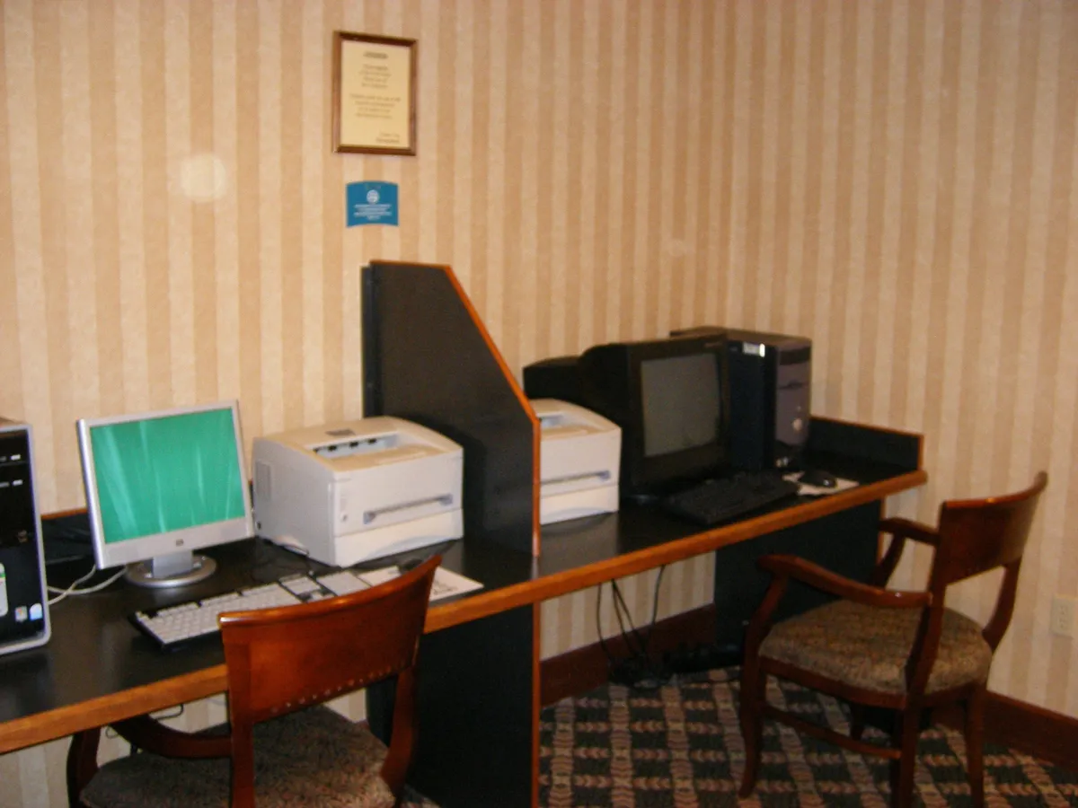 A practical business center equipped with computers, printers, and ergonomic chairs. The focused, quiet environment is designed for productivity, making it easy for business travelers or remote workers to stay connected and get work done efficiently.